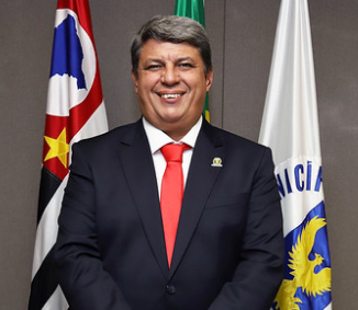 Fotografia do vice-prefeito Wanderley de Almeida, com as bandeiras de Campinas, do Estado de São Paulo, do Brasil e de Campinas ao fundo