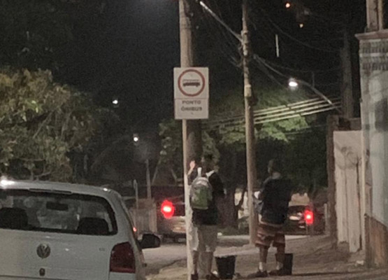 Rapazes afixando cartazes na noite anterior, terça-feira